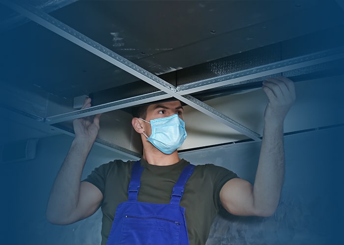 Technician performing commercial air duct cleaning in St Louis MO